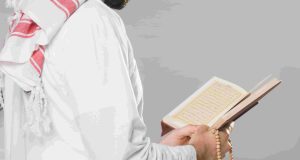 muslim-man-reading-from-quran-holding-praying-beads